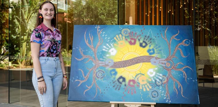 Merinda Walters with her artwork to commemorate 150 years of BOQ.
