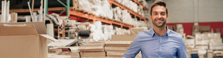 Person at their warehouse happy with their commercial rate loan