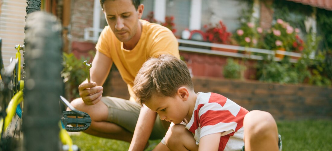 Father and son working in the garden of their home.