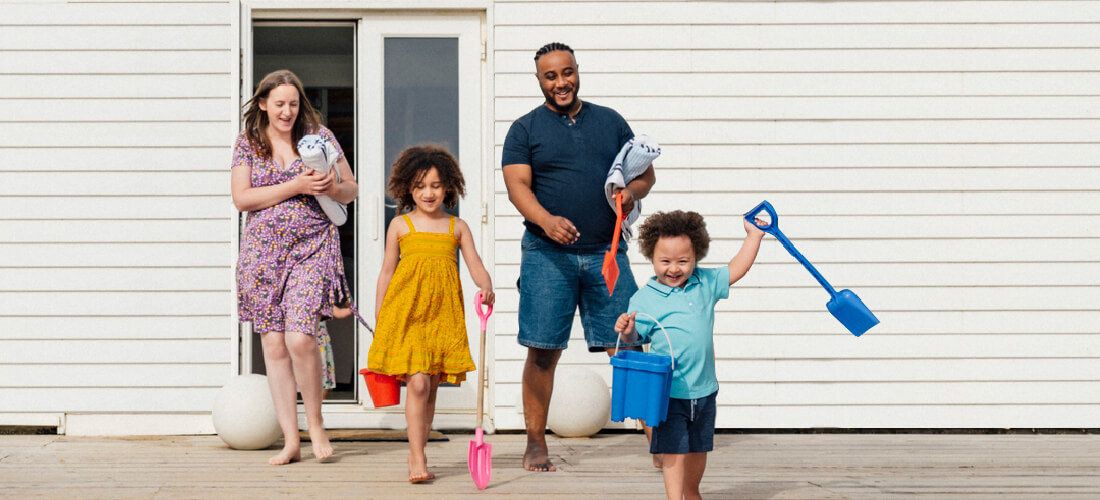 family running and smiling in the sunshine