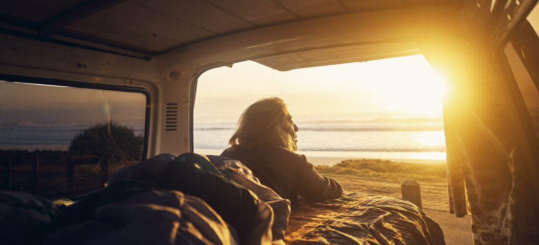 gil sun gazing from a van out at a beach.