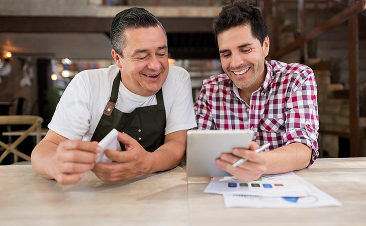 guy showing business owner iPad screen