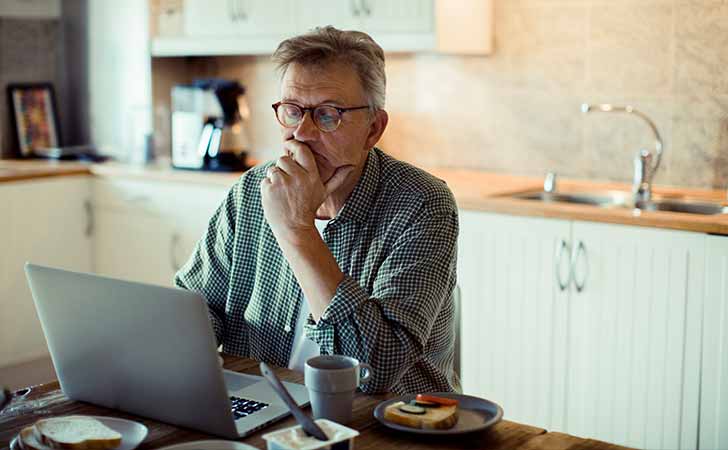 Older gentleman looking at laptop