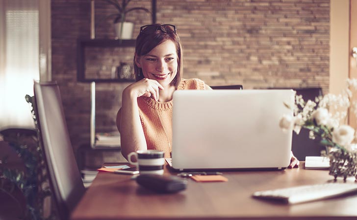 smiling woman reading the latest news from BOQ