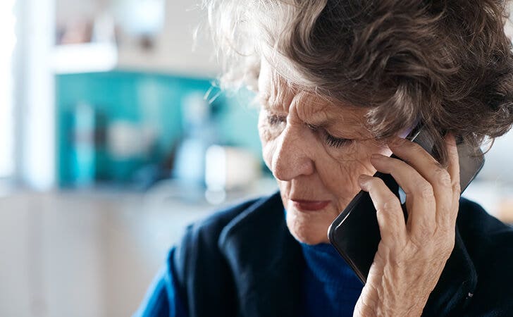 woman on the phone after learning about a fraud and scam